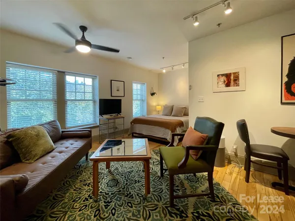 a living room with furniture fireplace and window