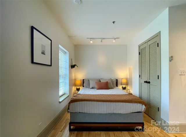 a bedroom with a bed and a lamp