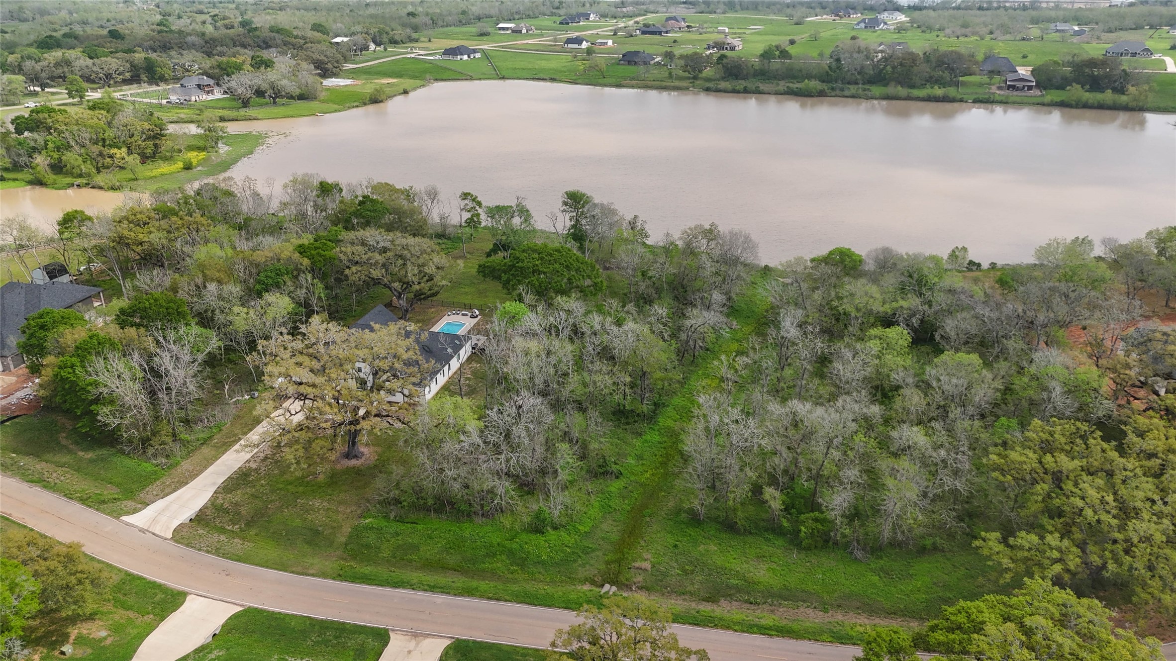 21502 Chenango Lake Drive Angleton, TX 77515 - Photo 1 of 18 an aerial view of a houses with a lake view