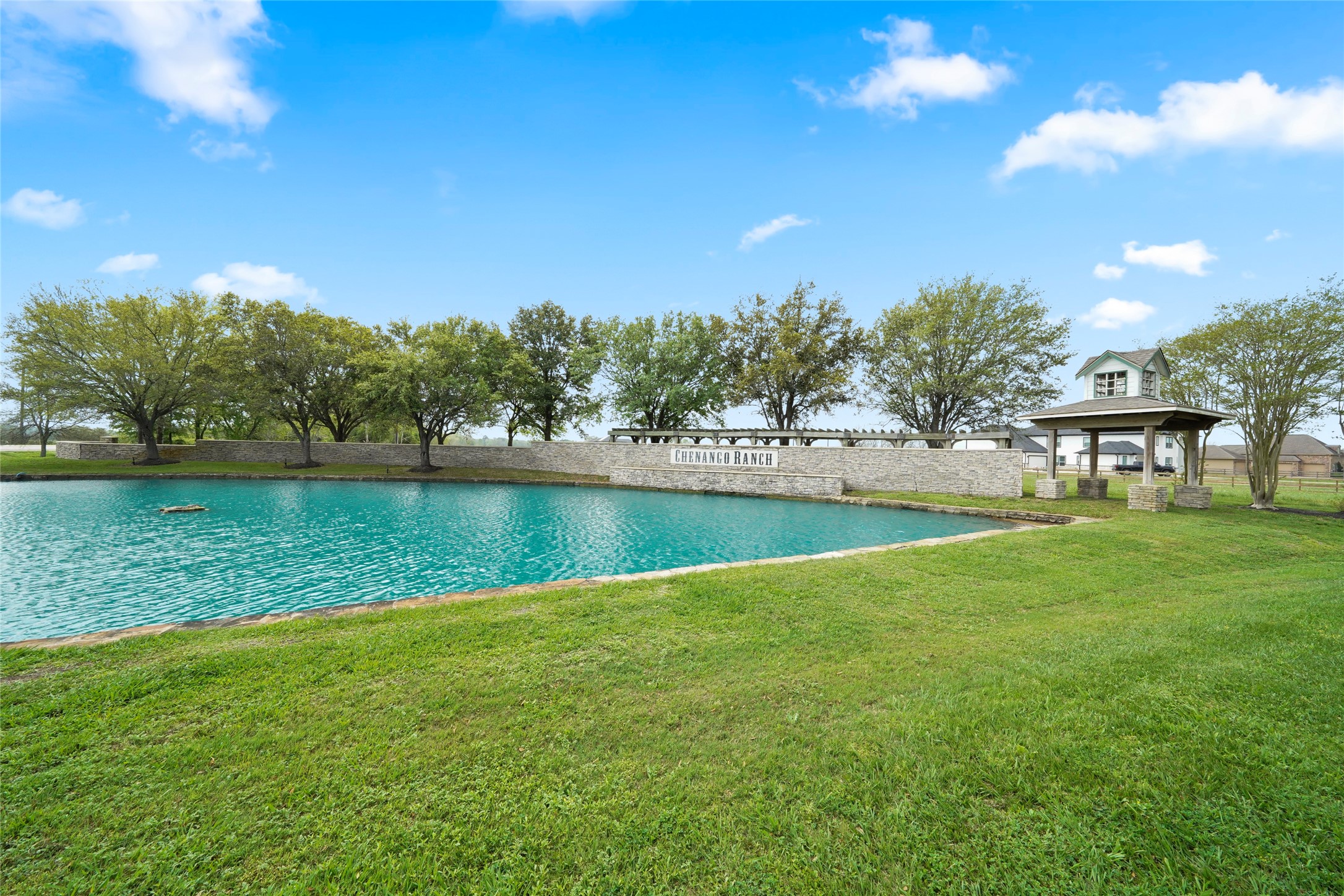 21502 Chenango Lake Drive Angleton, TX 77515 - Photo 18 of 18 a view of a lake with houses in the back