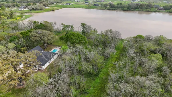 an aerial view of a houses with a lake view