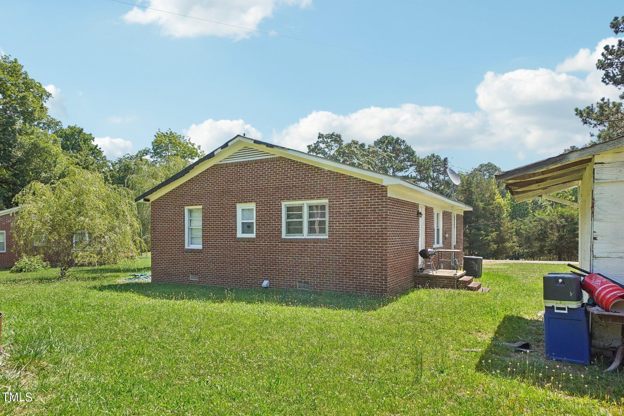 425 Kittrell Road Kittrell, NC 27544 - Photo 18 of 69 a backyard of a house with table and chairs