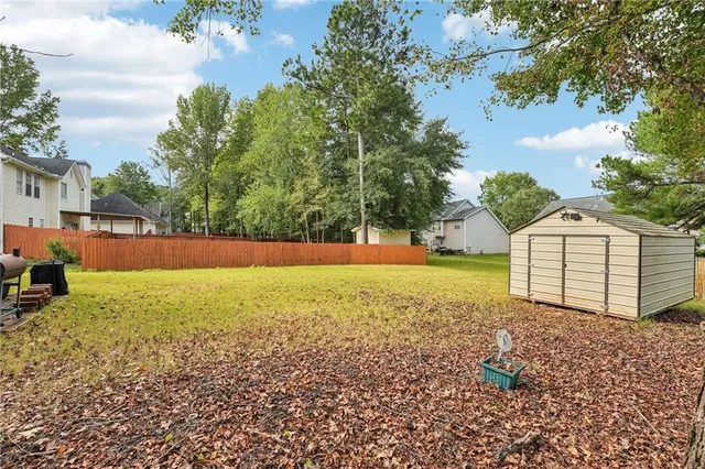 a view of a backyard with large trees