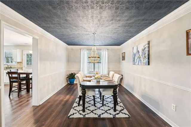 a dining room with furniture and wooden floor