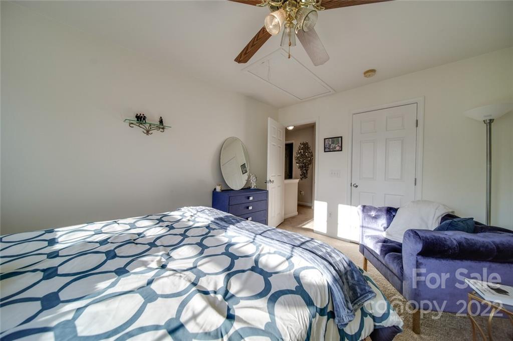 727 Prospect Lane Fort Mill, SC 29708 - Photo 35 of 43 a bed room with a bed mirror and a chandelier