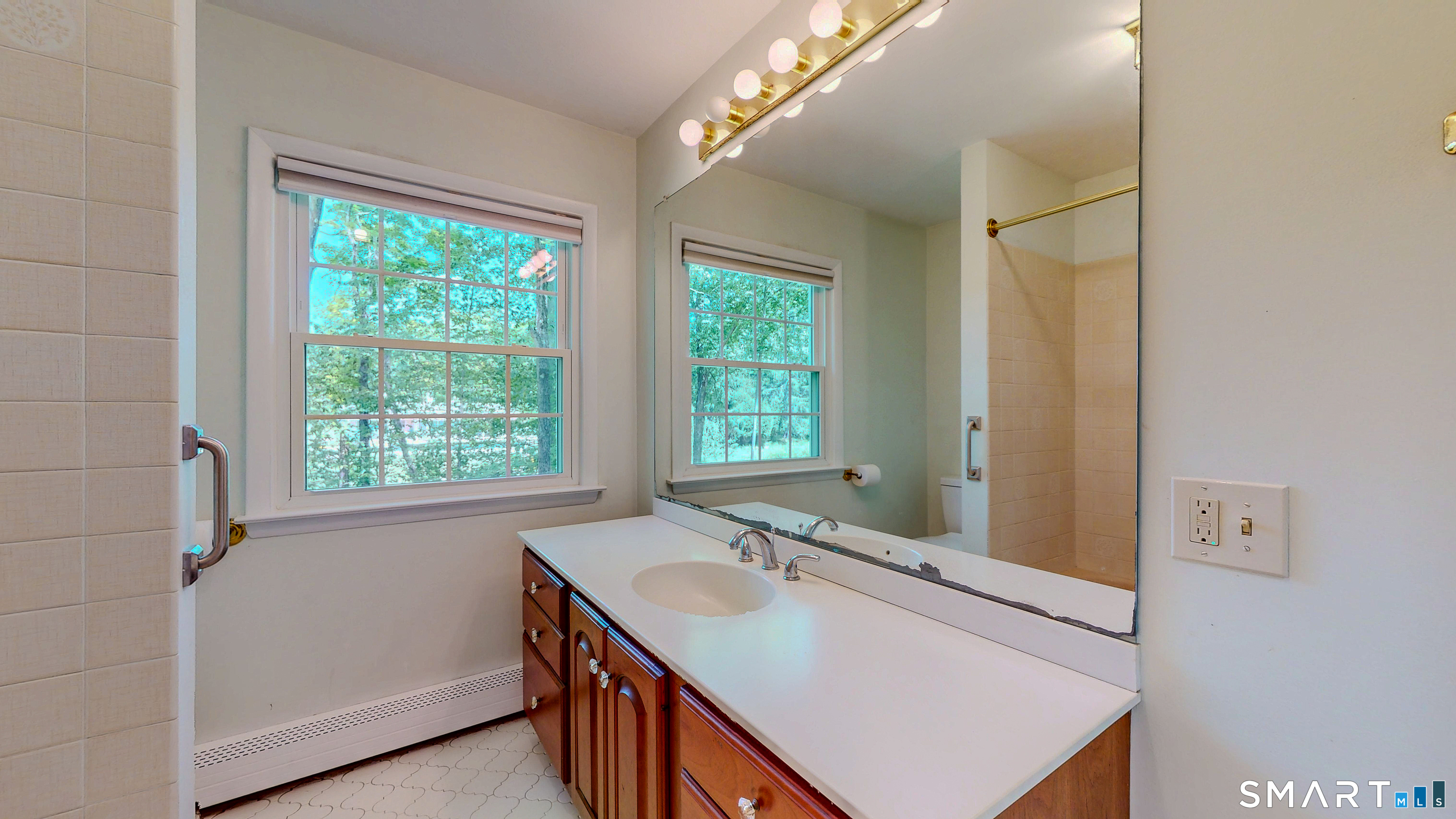 133 Chambers Road Danbury, CT 06811 - Photo 18 of 30 a bathroom with a sink and mirror with window