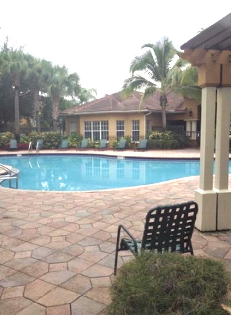 5032 Lantana Road, Unit 2105 Lake Worth, FL 33463 - Photo 13 of 15 a view of a house with backyard and sitting area