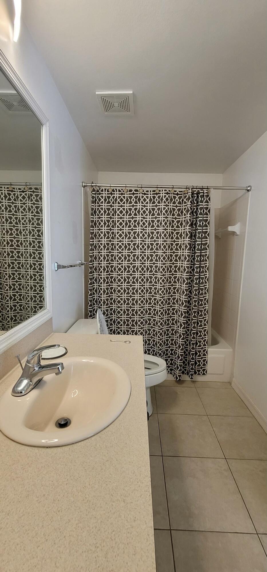 5032 Lantana Road, Unit 2105 Lake Worth, FL 33463 - Photo 8 of 15 a bathroom with a bathtub and shower