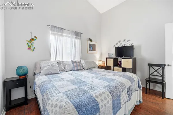 a bedroom with a bed a window and lamps