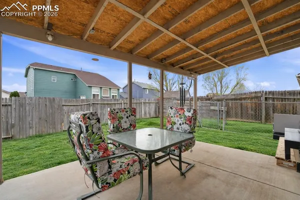 a view of a backyard with furniture and a garden
