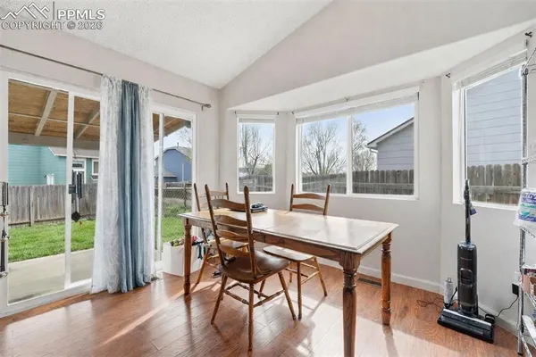 a view of a dining room with furniture window and wooden floor