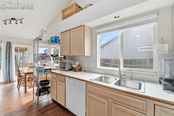a kitchen with a window a sink and cabinets