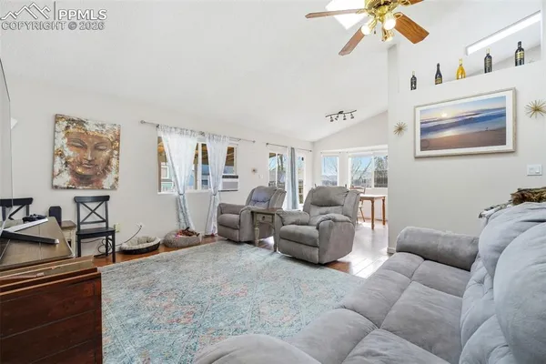 a living room with furniture and a chandelier