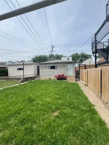 a view of a backyard with table and chairs