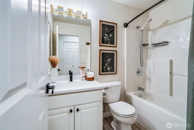 a bedroom with a bed and a painting on the wall