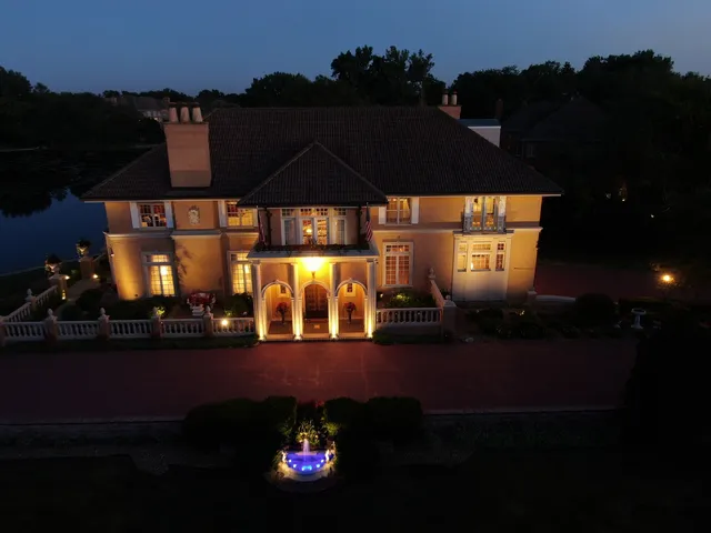 a view of a room with a chandelier and a ceiling fan