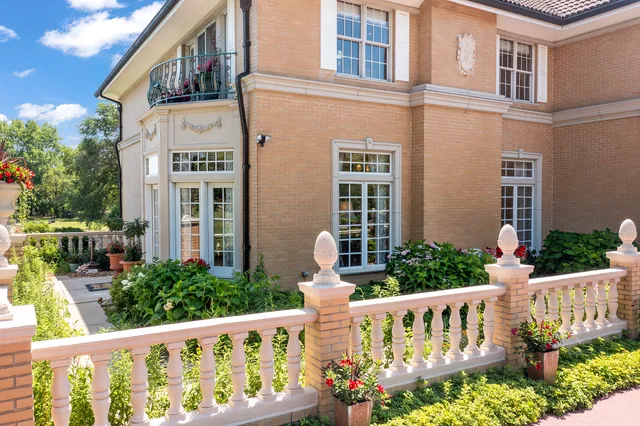 an aerial view of residential houses with outdoor space and trees