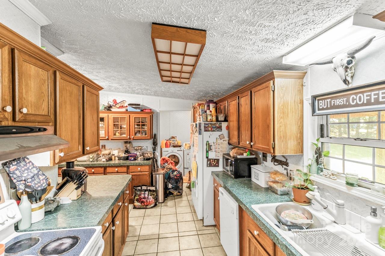 4155 Slanting Bridge Road Sherrills Ford, NC 28673 - Photo 17 of 34 a kitchen with a large window and a sink