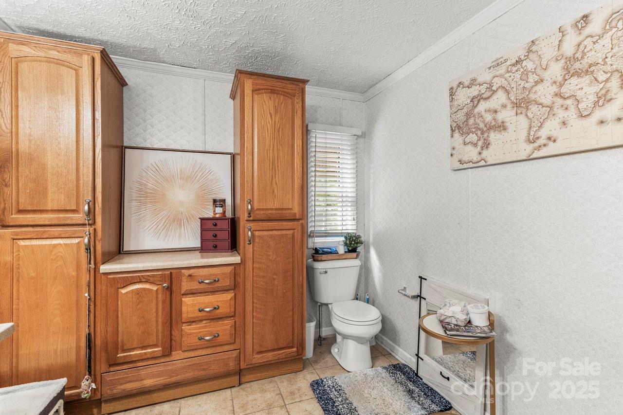 4155 Slanting Bridge Road Sherrills Ford, NC 28673 - Photo 22 of 34 a bathroom with a toilet sink and tub
