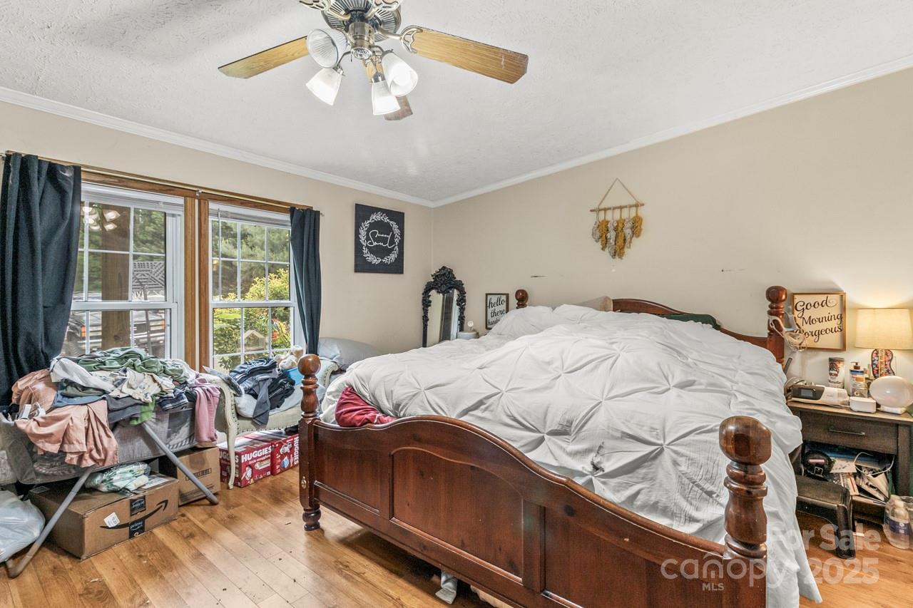 4155 Slanting Bridge Road Sherrills Ford, NC 28673 - Photo 25 of 34 a bedroom with a bed and wooden floor