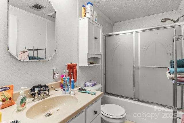 a room with furniture a baby crib and a couch