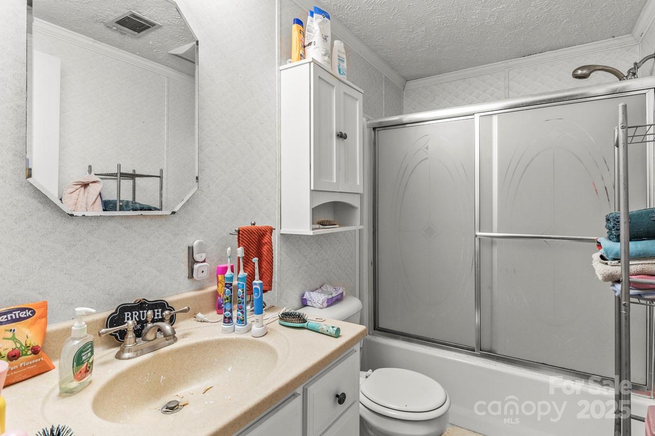 4155 Slanting Bridge Road Sherrills Ford, NC 28673 - Photo 27 of 34 a bathroom with a sink toilet and shower