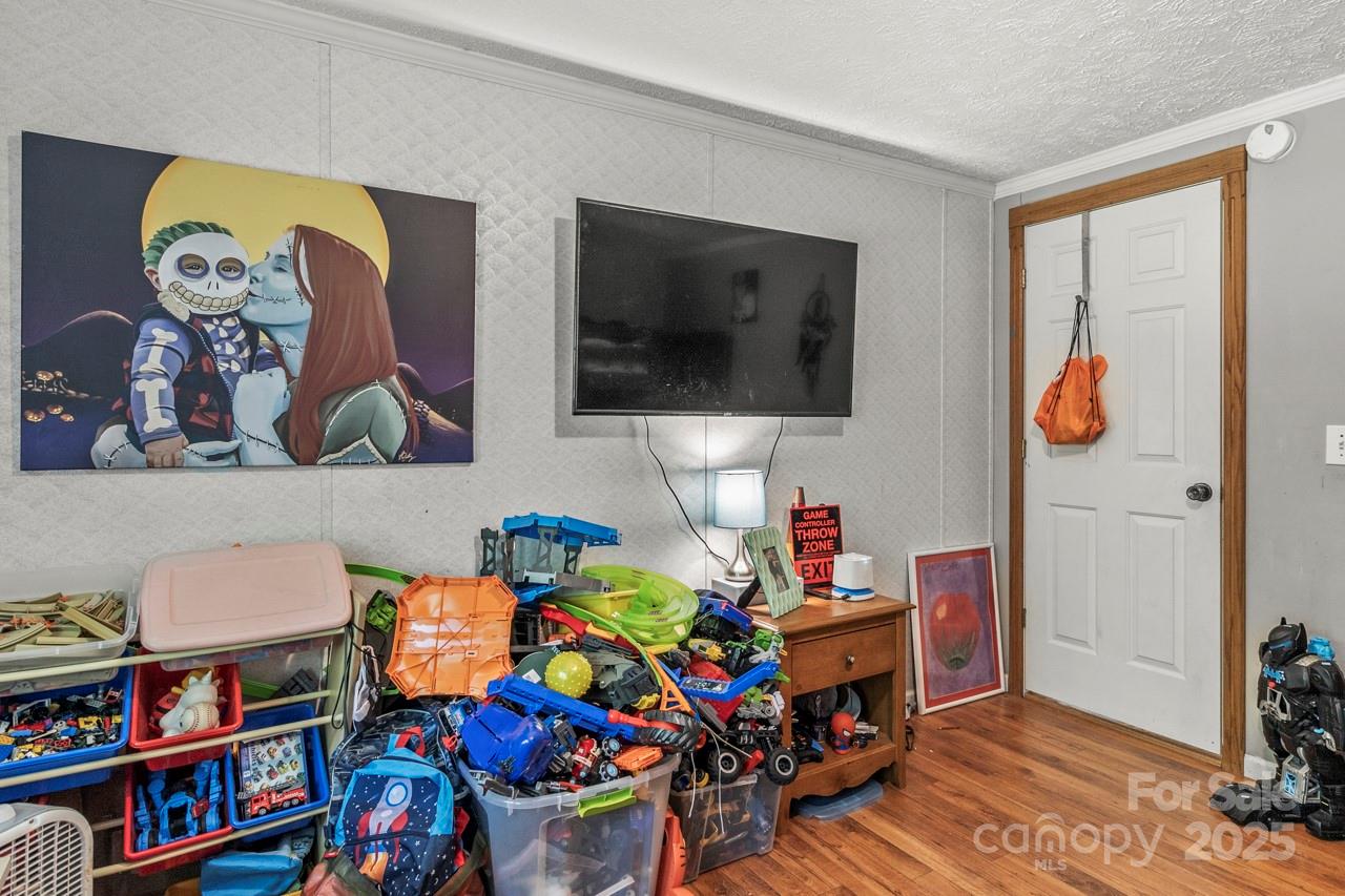 4155 Slanting Bridge Road Sherrills Ford, NC 28673 - Photo 28 of 34 a room with furniture a baby crib and a couch