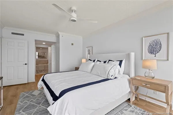 a bedroom with a bed and a lamp on dresser