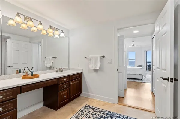a spacious bathroom with a shower a sink and a mirror
