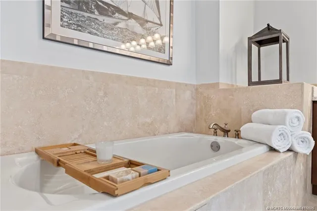 a bathroom with a tub and a window