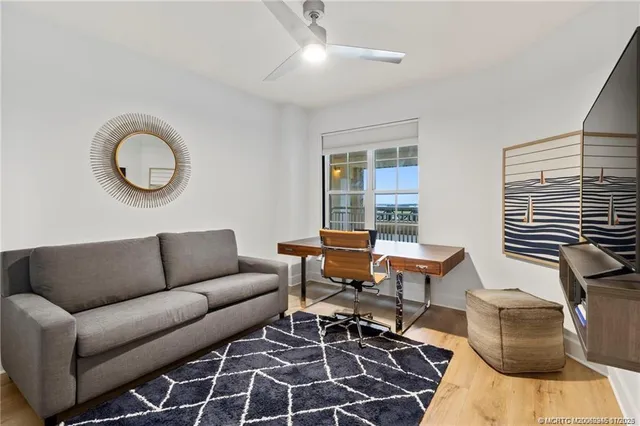 a living room with furniture a table and a large window