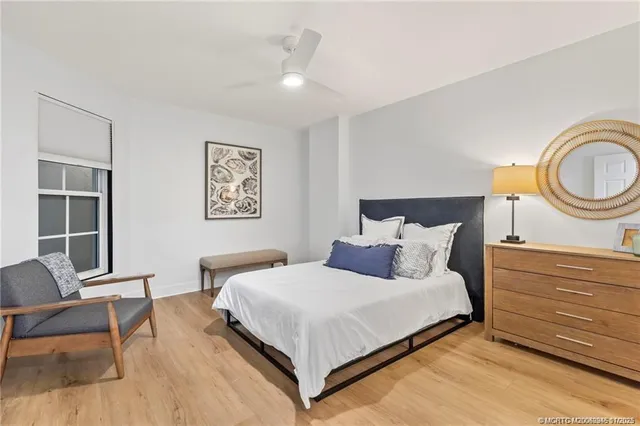 a bedroom with a bed and chair