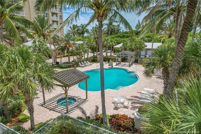 a view of a swimming pool with a table and chairs