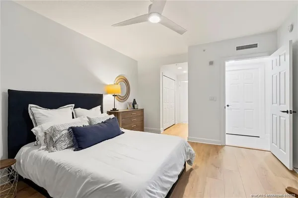 a bedroom with bed and a chandelier