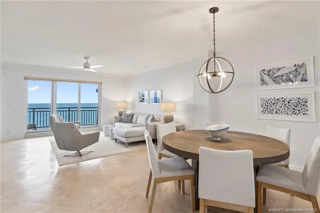 a view of a dining room with furniture wooden floor and a chandelier