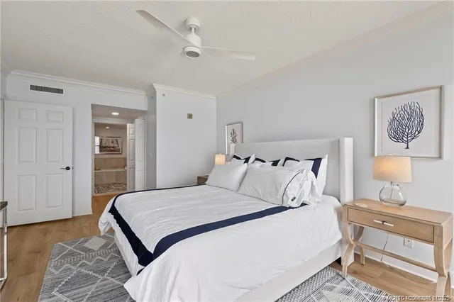 a bedroom with a bed and a lamp on dresser