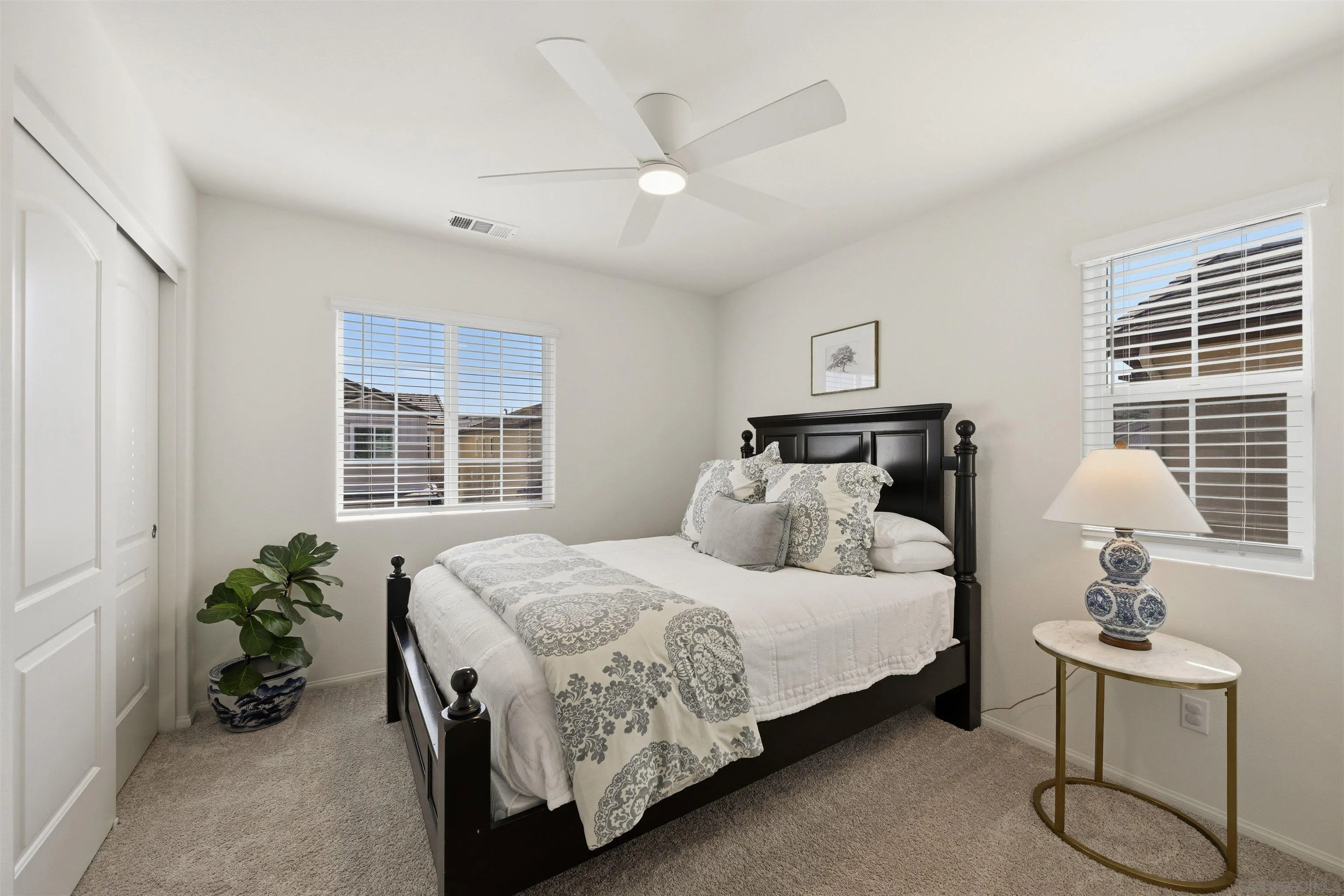 5616 Daybreak Way Bonsall, CA 92003 - Photo 13 of 24 a bedroom with a bed and potted plant