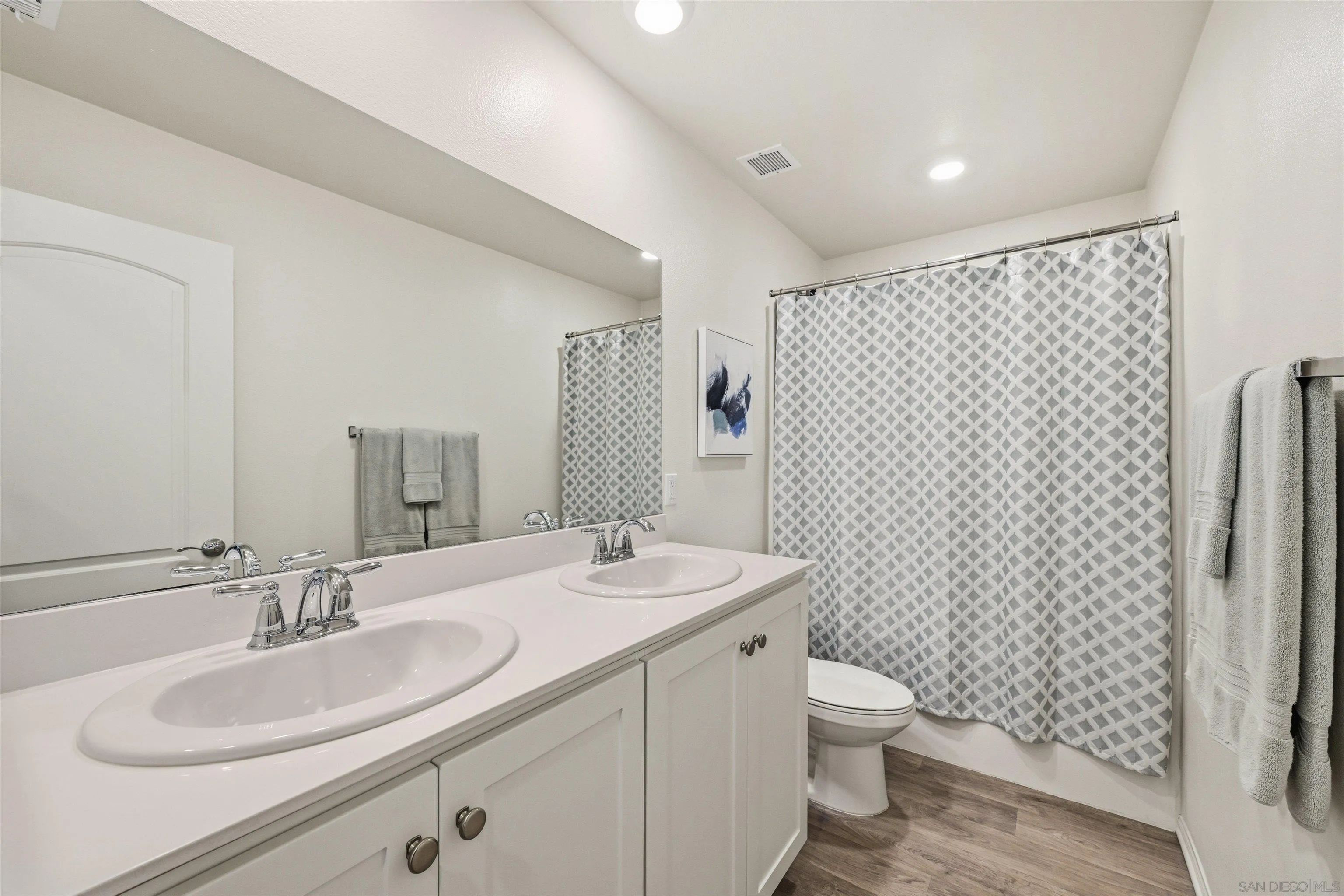 5616 Daybreak Way Bonsall, CA 92003 - Photo 14 of 24 a bathroom with a sink toilet and shower