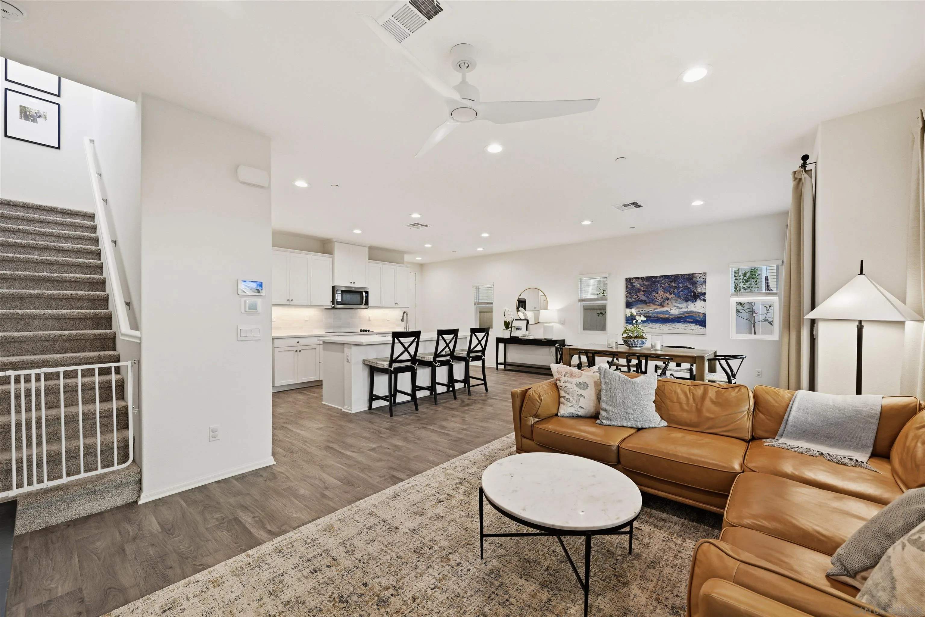 5616 Daybreak Way Bonsall, CA 92003 - Photo 2 of 24 a living room with furniture a rug and kitchen view