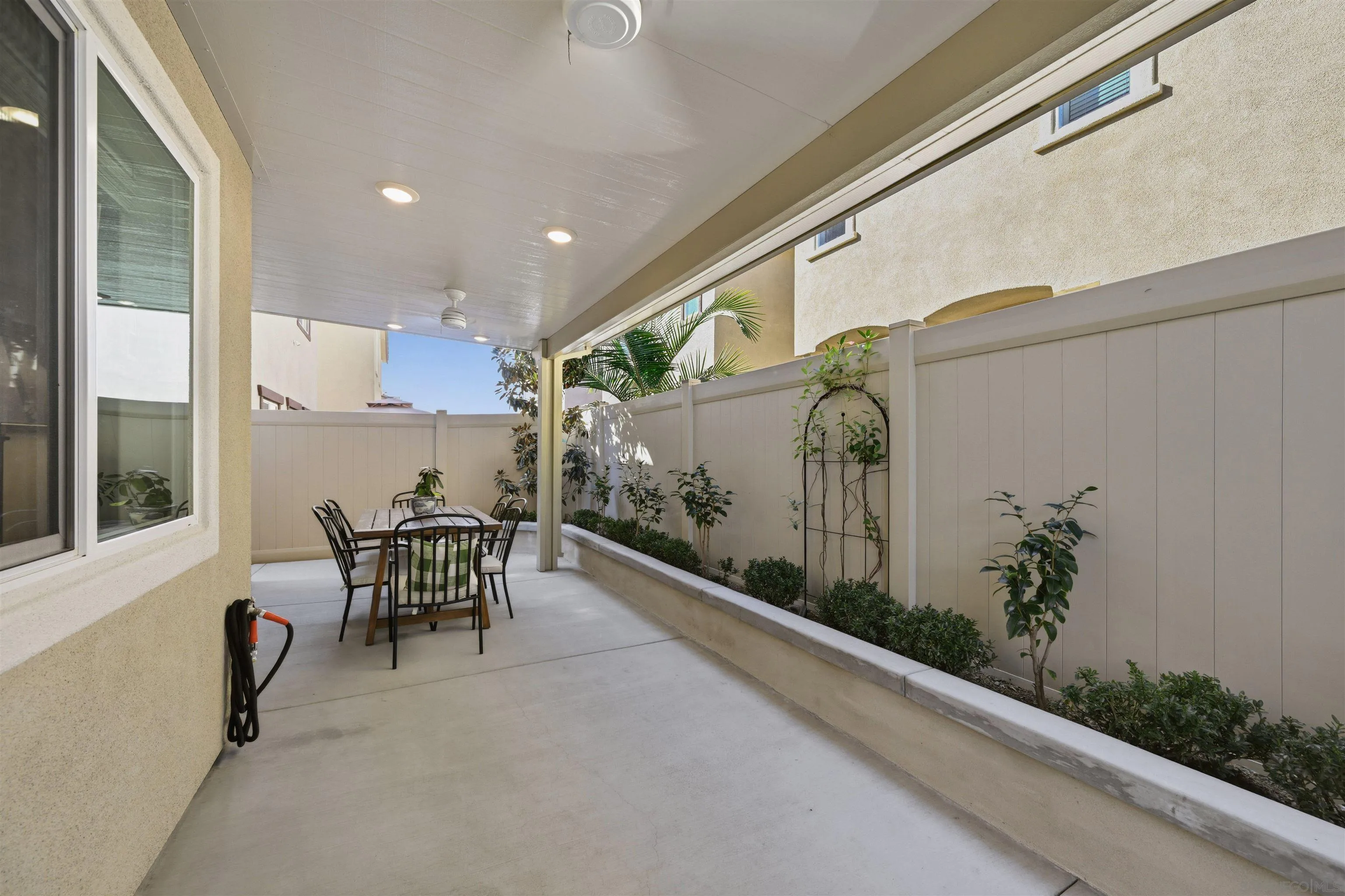 5616 Daybreak Way Bonsall, CA 92003 - Photo 22 of 24 a view of a patio with table and chairs and potted plants