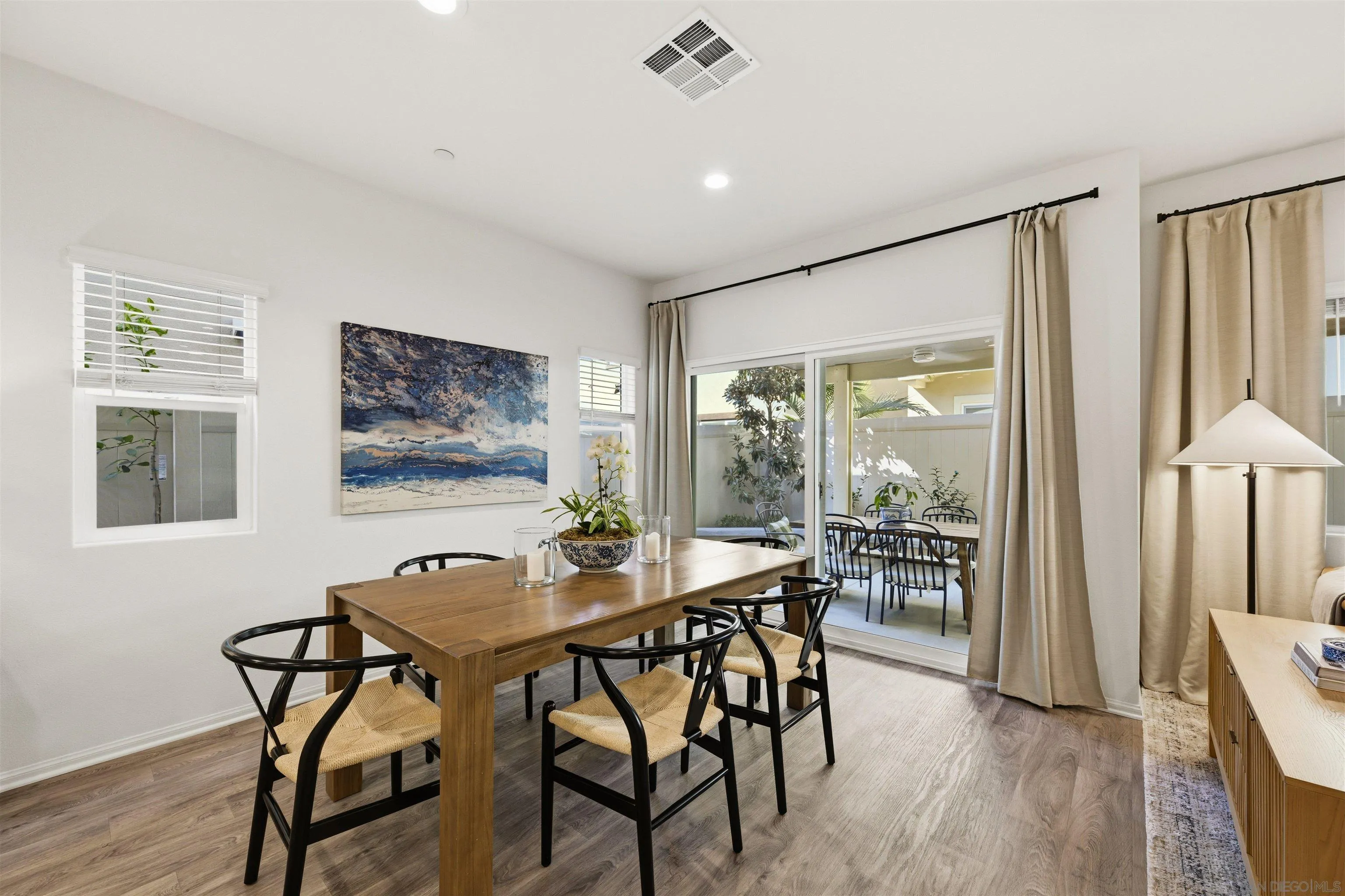 5616 Daybreak Way Bonsall, CA 92003 - Photo 7 of 24 a view of a dining room with furniture window and wooden floor