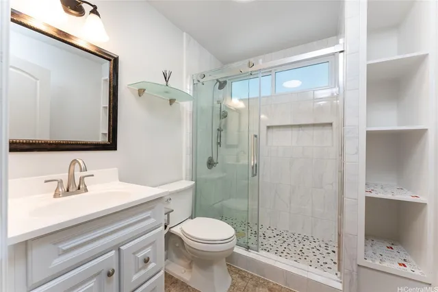 a bathroom with a sink a toilet and shower