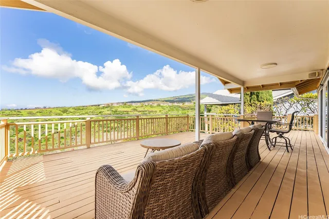 a balcony with furniture and wooden floor