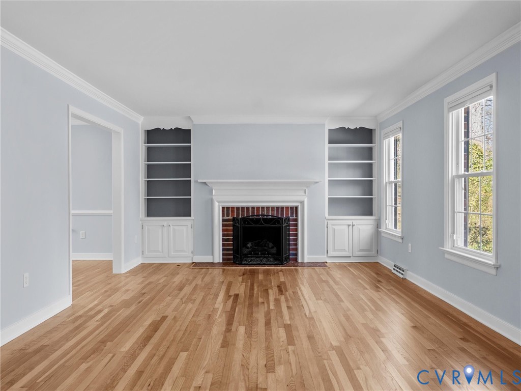 1330 Winslow Road Richmond, VA 23235 - Photo 11 of 46 a view of an empty room with wooden floor fireplace and a window