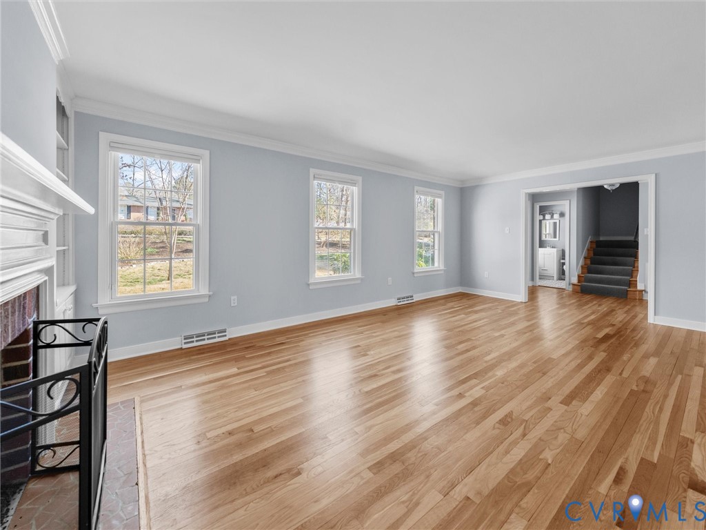 1330 Winslow Road Richmond, VA 23235 - Photo 12 of 46 an empty room with wooden floor and windows