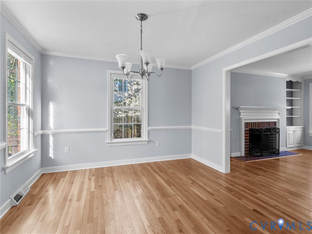 1330 Winslow Road Richmond, VA 23235 - Photo 14 of 46 a view of an empty room with wooden floor fireplace and a window