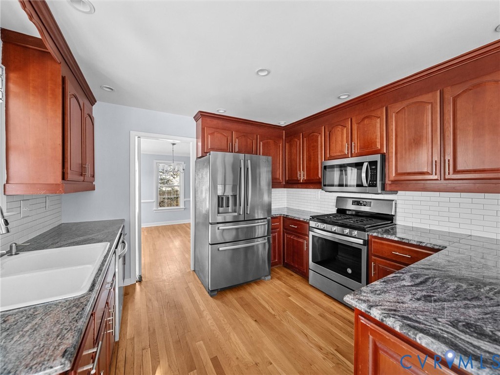 1330 Winslow Road Richmond, VA 23235 - Photo 16 of 46 a kitchen with wooden cabinets and stainless steel appliances