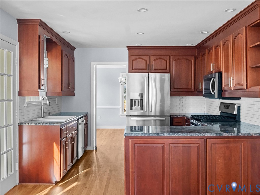 1330 Winslow Road Richmond, VA 23235 - Photo 17 of 46 a kitchen with stainless steel appliances granite countertop a stove a sink and a refrigerator