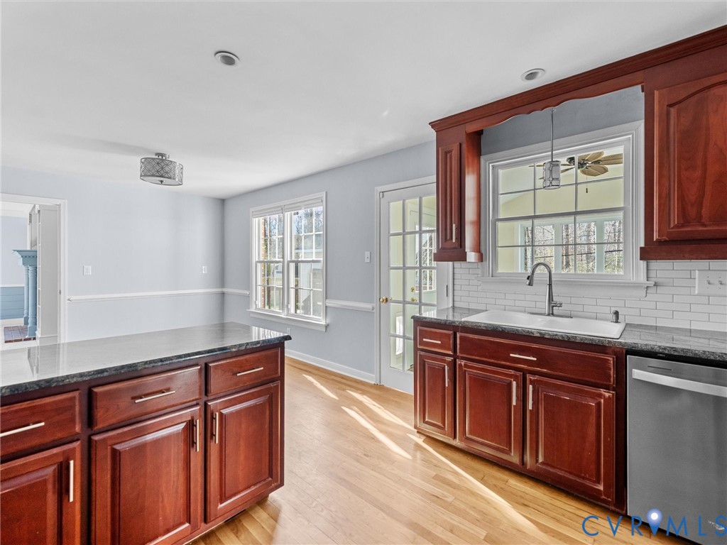 1330 Winslow Road Richmond, VA 23235 - Photo 18 of 46 a kitchen with granite countertop stainless steel appliances a sink stove and cabinets