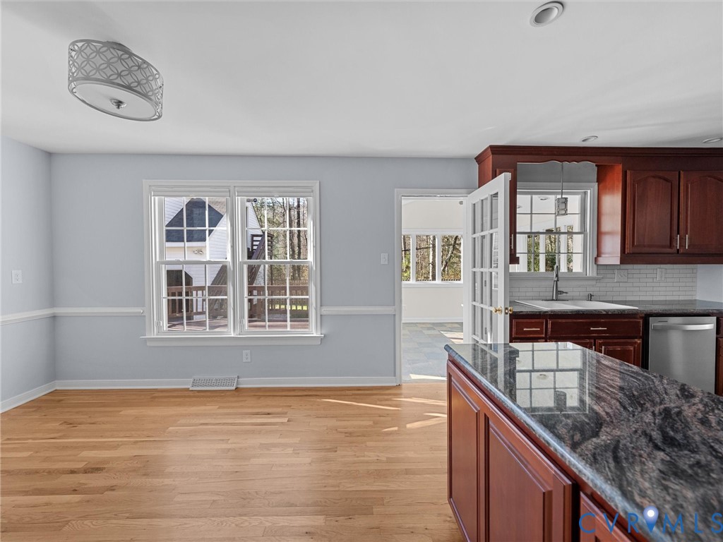 1330 Winslow Road Richmond, VA 23235 - Photo 19 of 46 a view of an empty room with window and kitchen